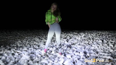 Blonde babe crouches to piss in the dark