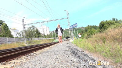 Blonde babe Debora pees next to railway line