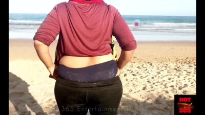 Housewife teases in the Beach – Shows her milky cleavage